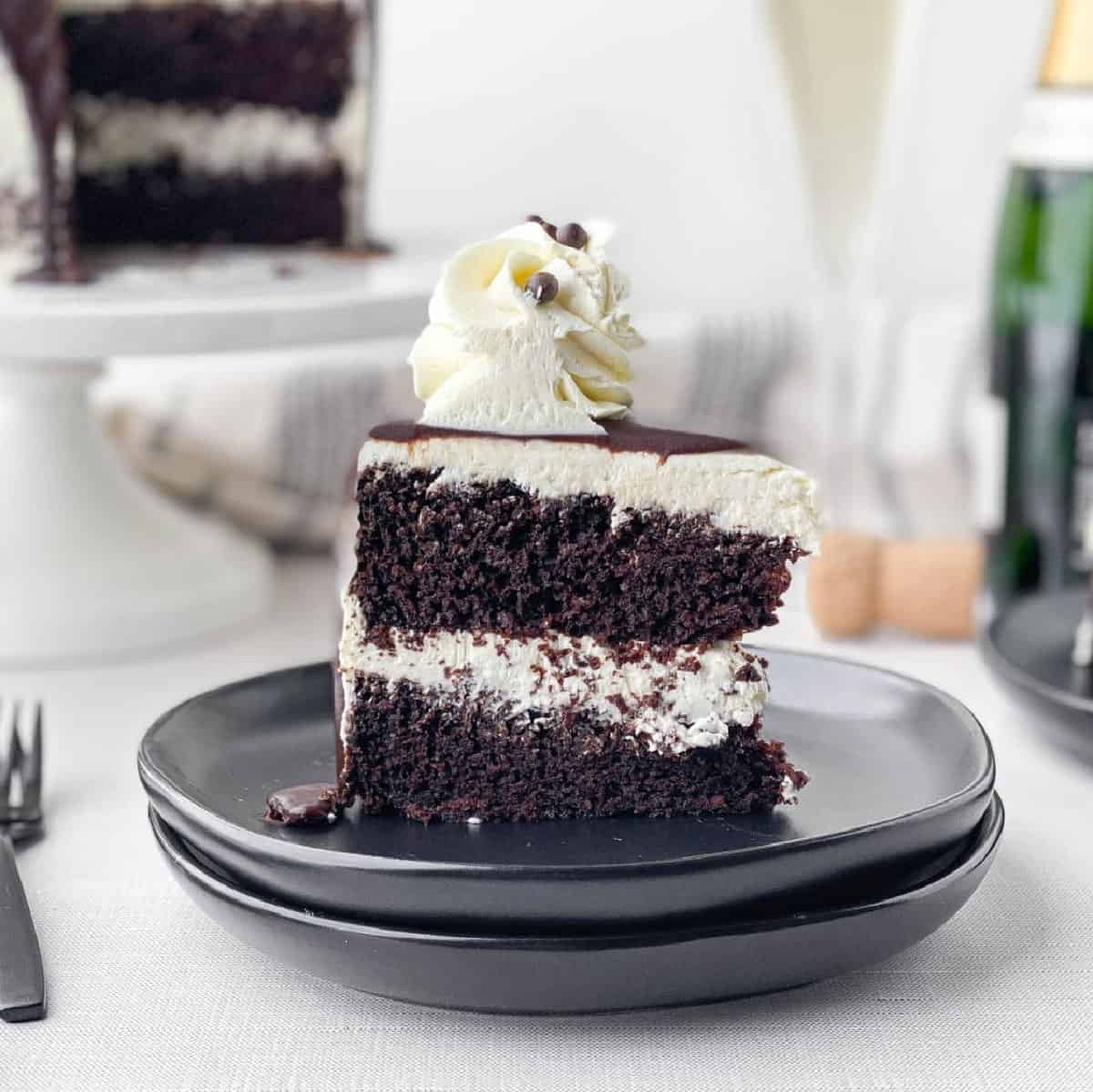 Slice of Chocolate Champagne Cake on a black plate.