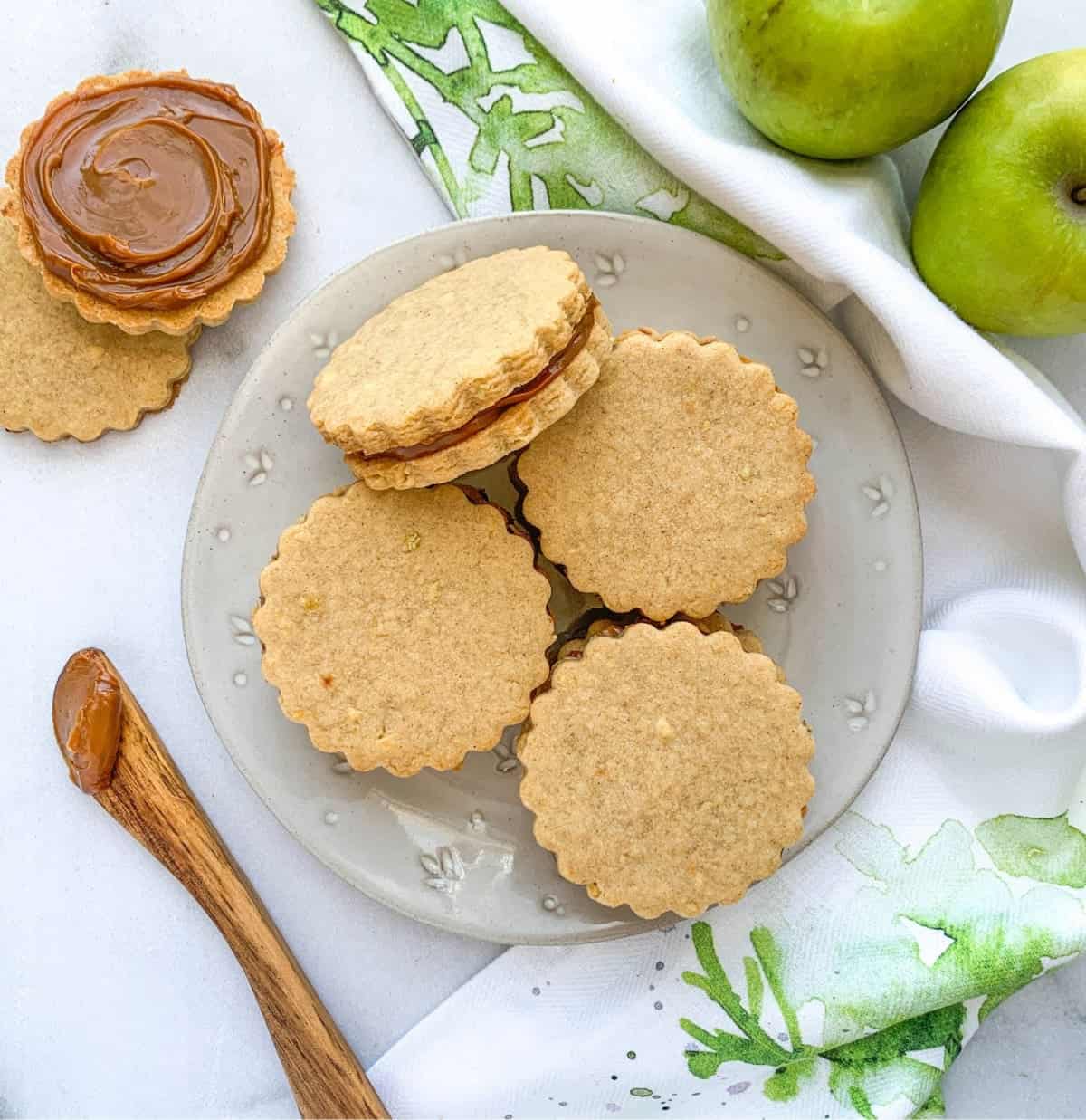 Caramel Apple Cookies stacked on a white plate.