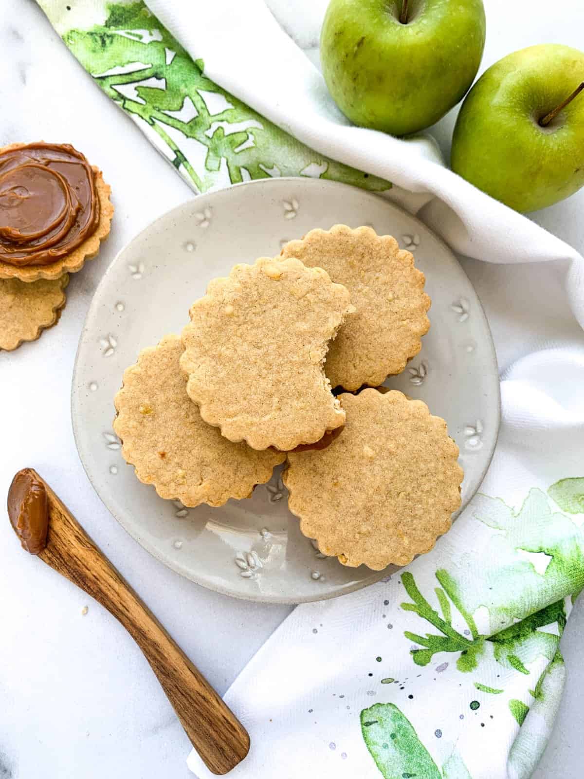 Caramel Apple Cookies with bite on a white plate.