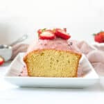 Sliced Lavender Pound Cake with Strawberry Glaze on a white plate.