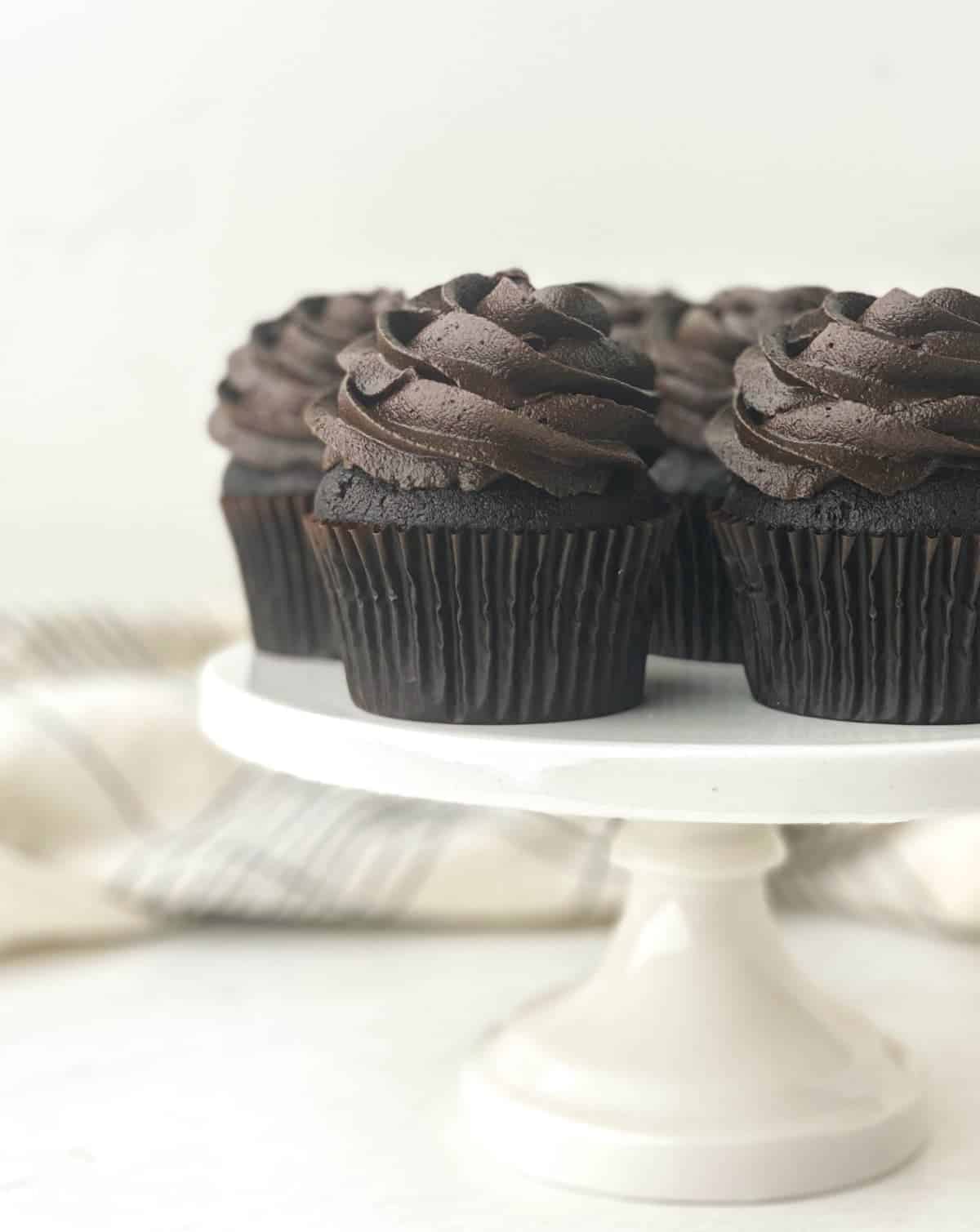 Black Velvet Cupcakes on a white cake stand.