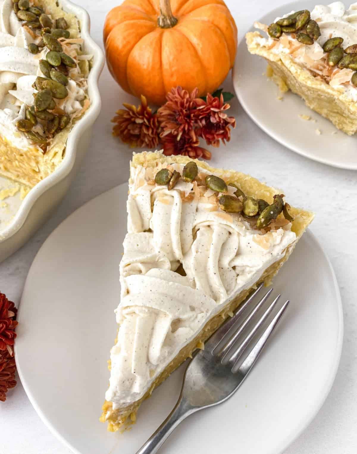Slice of Pumpkin Coconut Cream Pie on a white plate from above