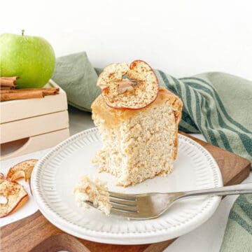 Partially eaten slice of Caramel Apple Angel Food Cake on a white plate.