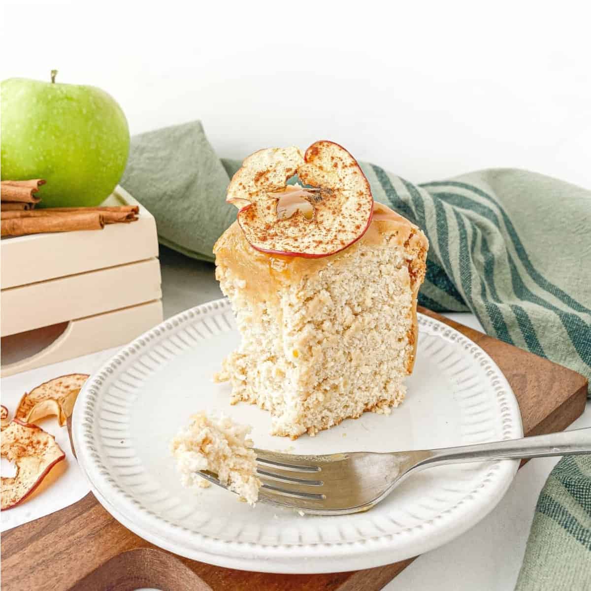 Partially eaten slice of Caramel Apple Angel Food Cake on a white plate.