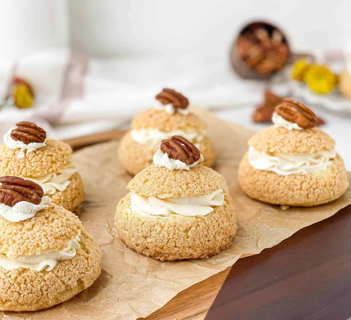 Pecan Pie Cream Puffs lined up on a serving board