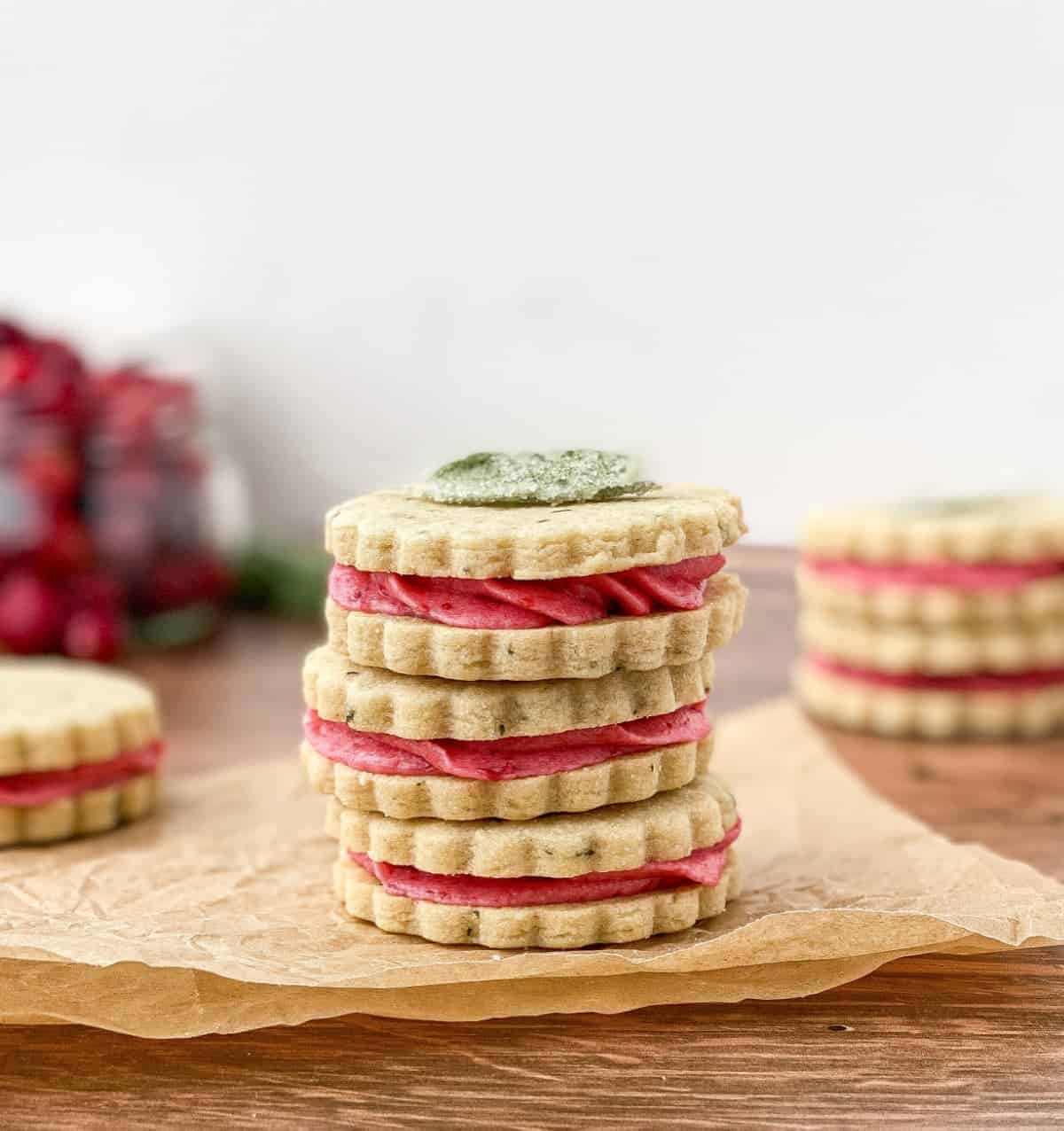 A stack of three Cranberry Sage Cookies with more cookies in the background