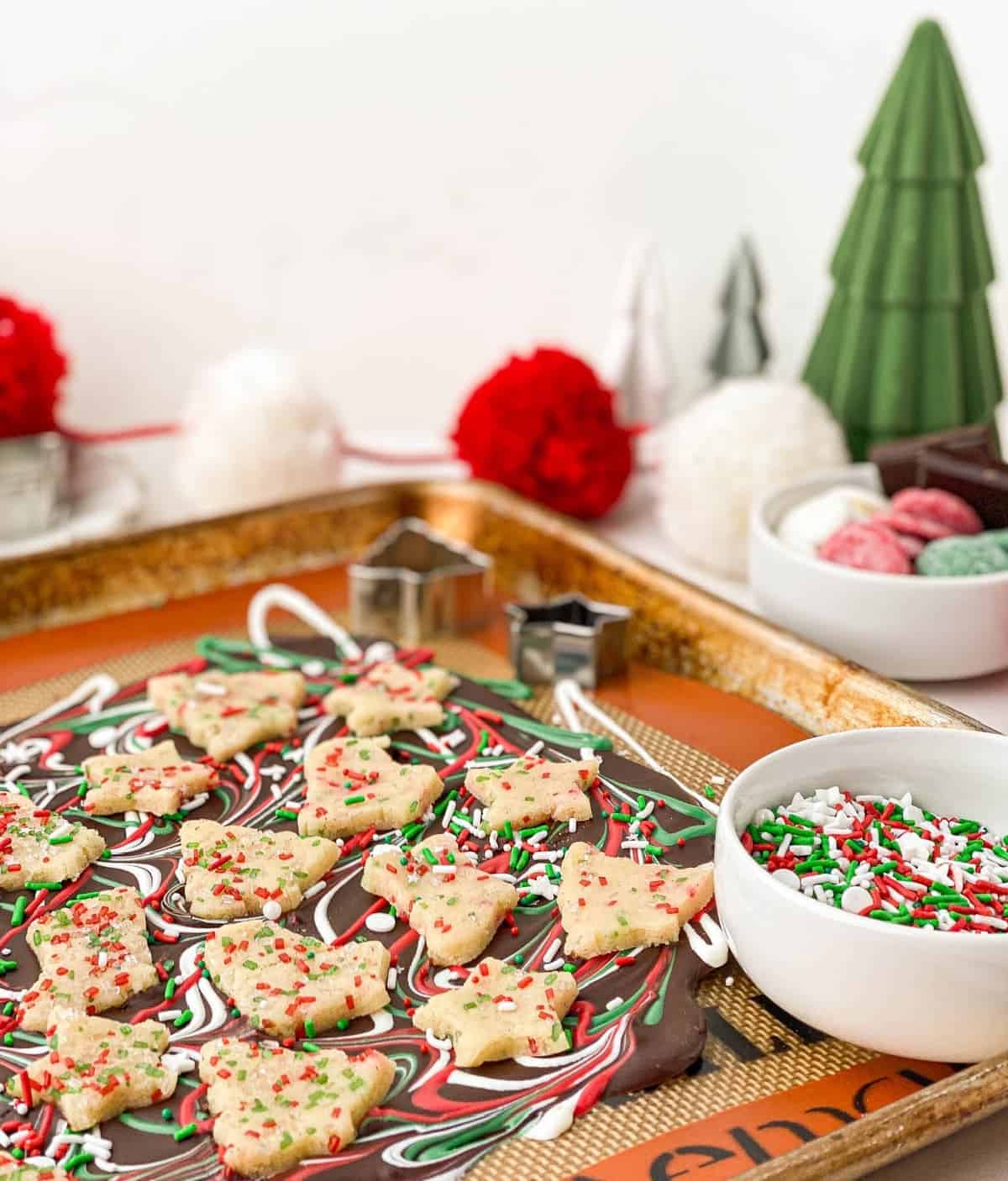 Sugar Cookie Dough Bark on a cookie sheet with sprinkles in a white bowl
