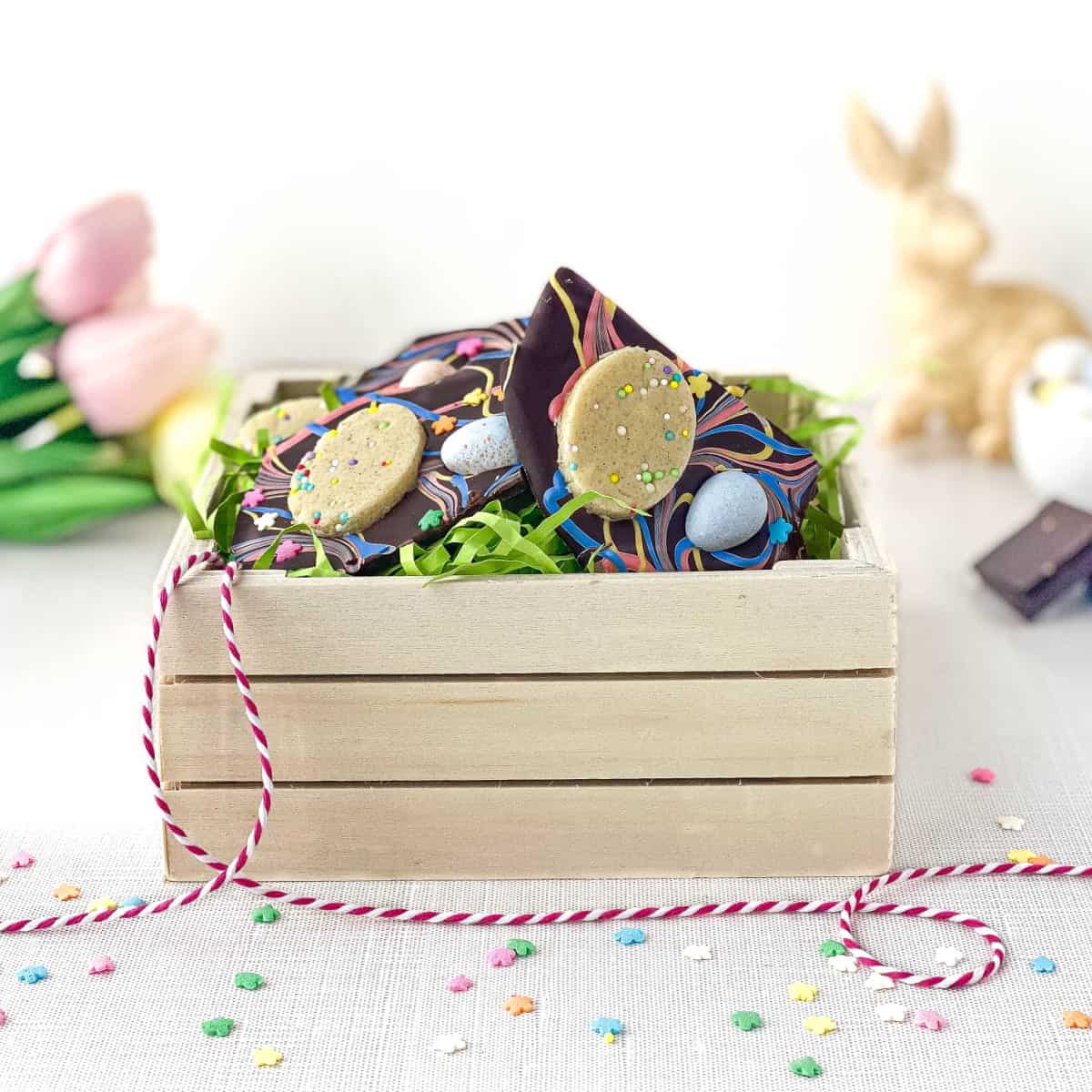Easter Cookie Dough Bark in a small wooden crate with Easter grass.