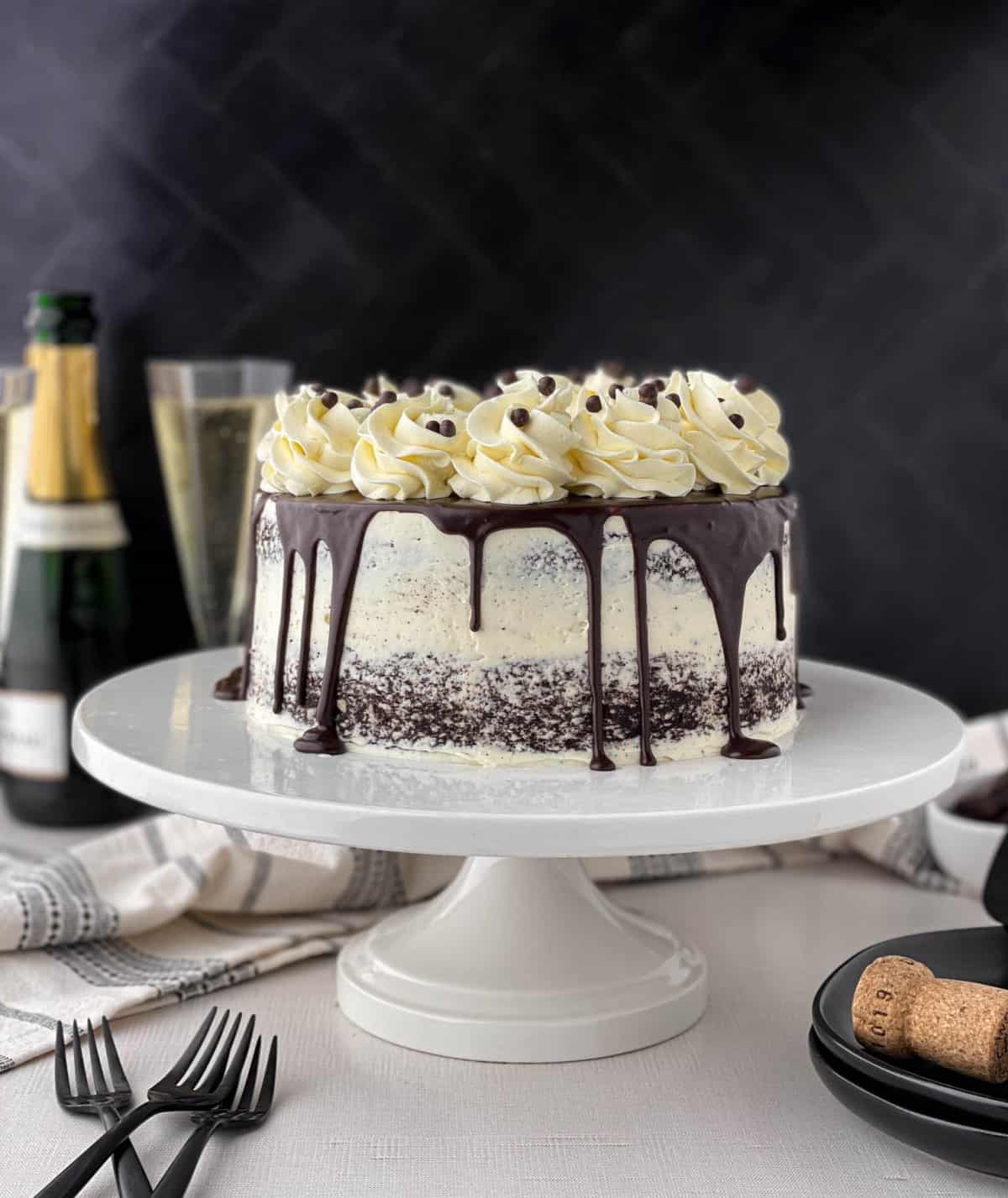 Chocolate Champagne Cake on a white cake stand.