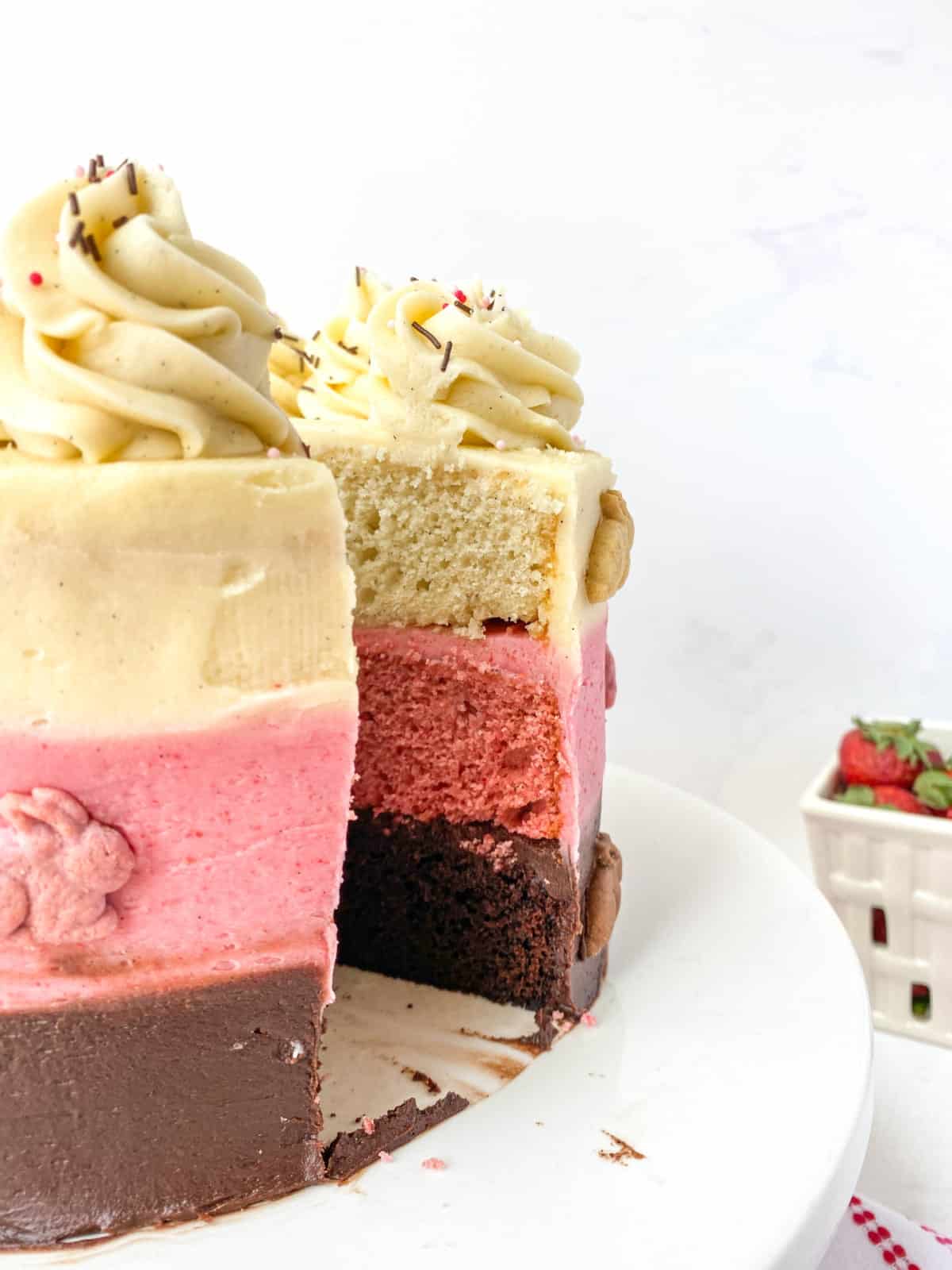 Closeup of Neapolitan Cake with a slice missing.