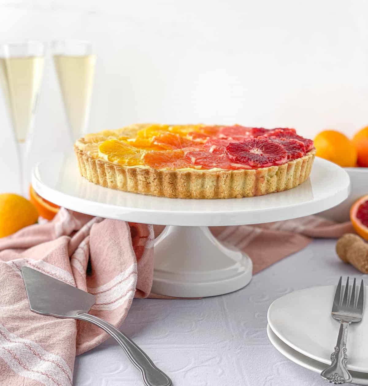 Champagne Citrus Tart on a white stand.