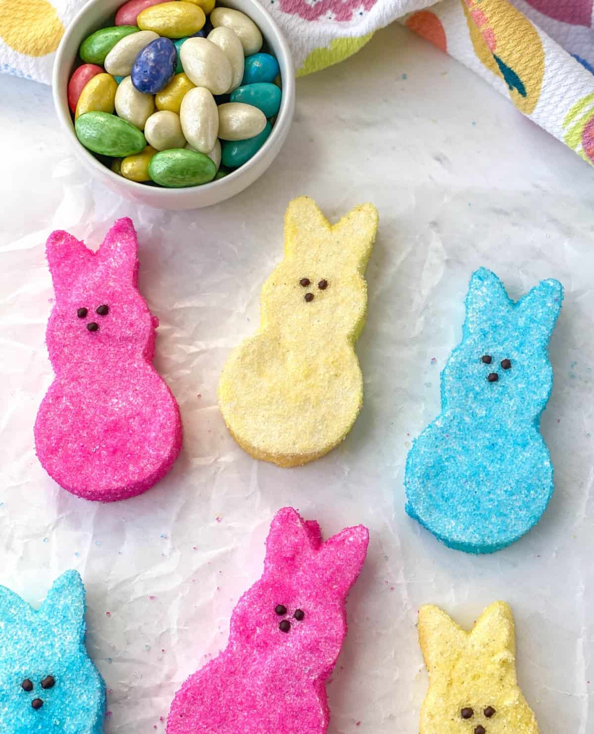 Top view of homemade pink, blue, and yellow bunny-shaped marshmallow peeps.