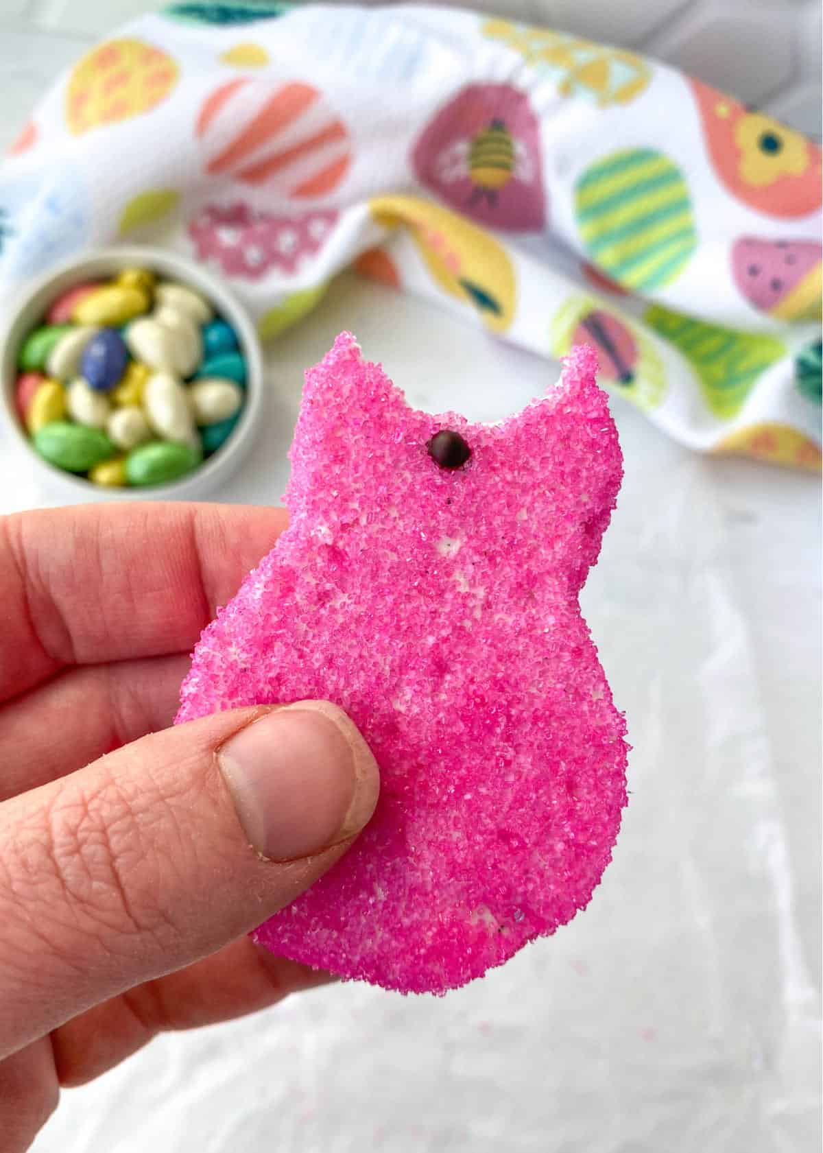 Closeup of a pink Homemade Peep with a bite out of it.