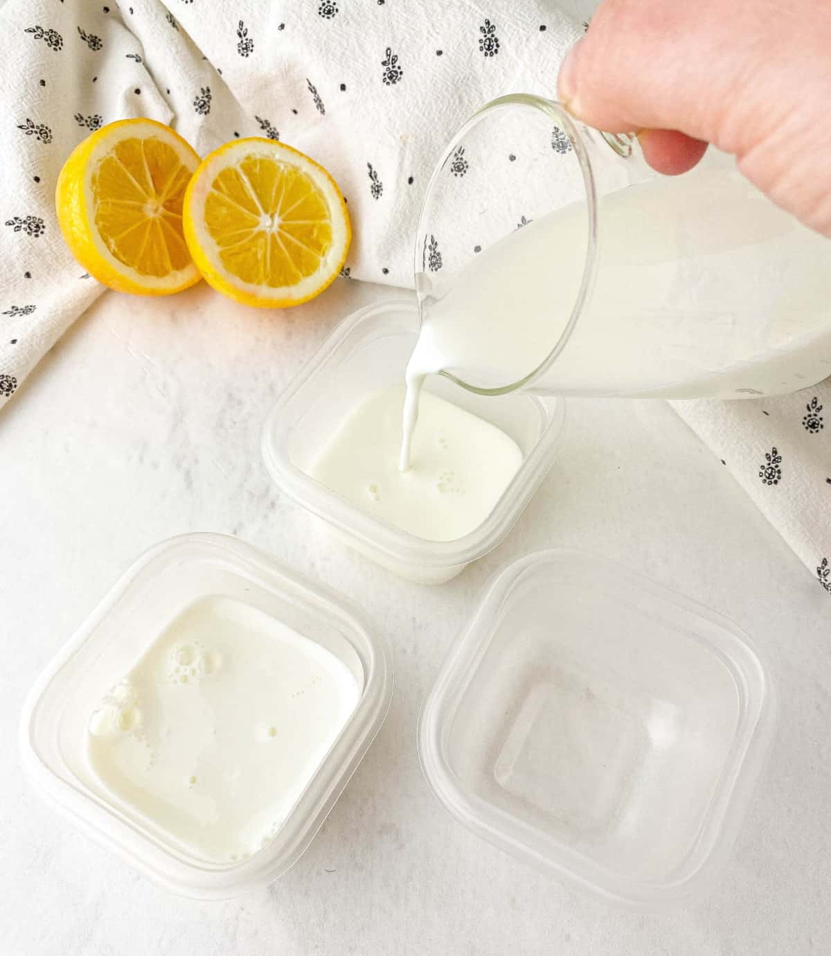 Pouring buttermilk into small containers to freeze.