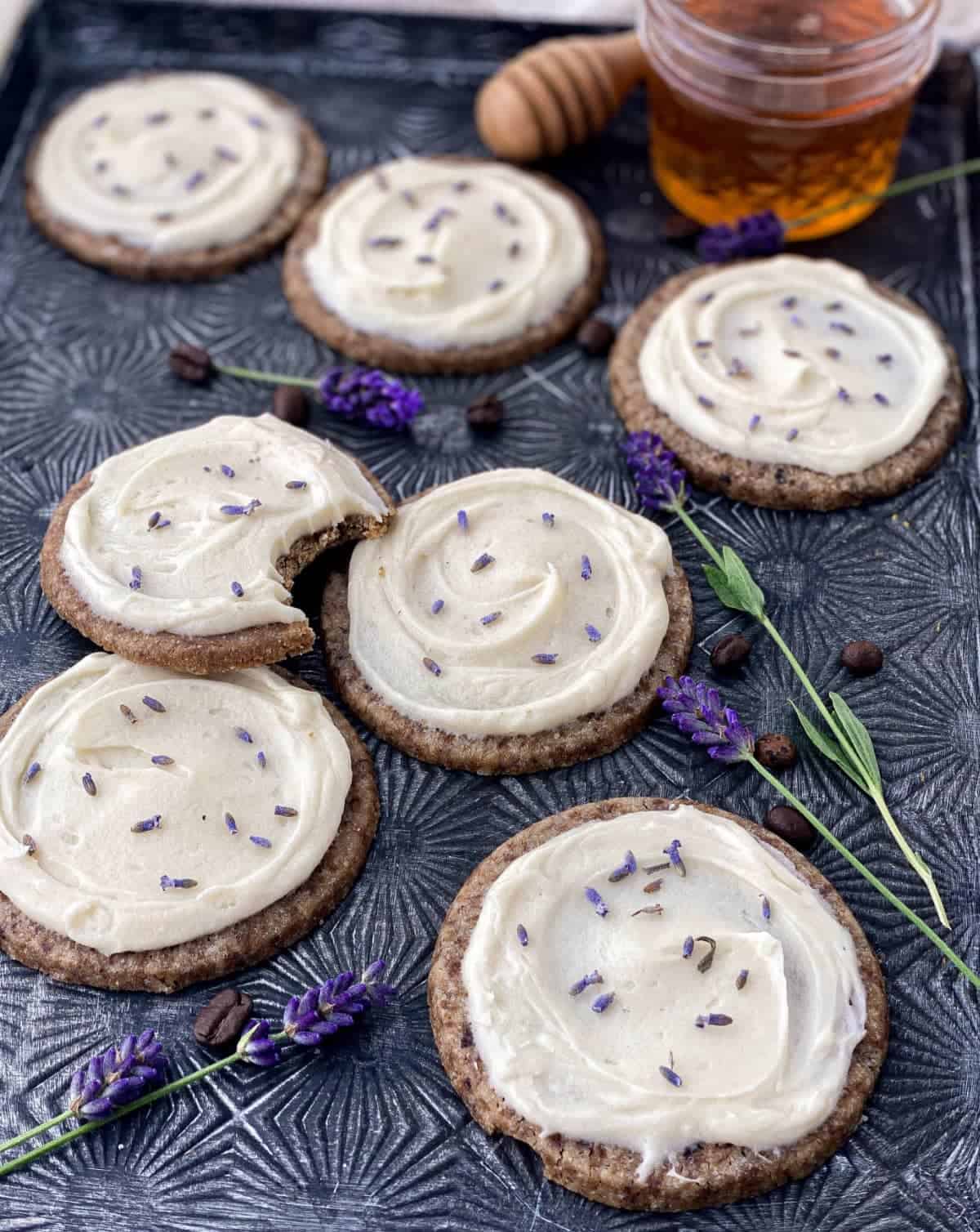 https://livetosweet.com/wp-content/uploads/2022/06/honey-lavender-latte-cookies-on-pan-with-honey.jpg