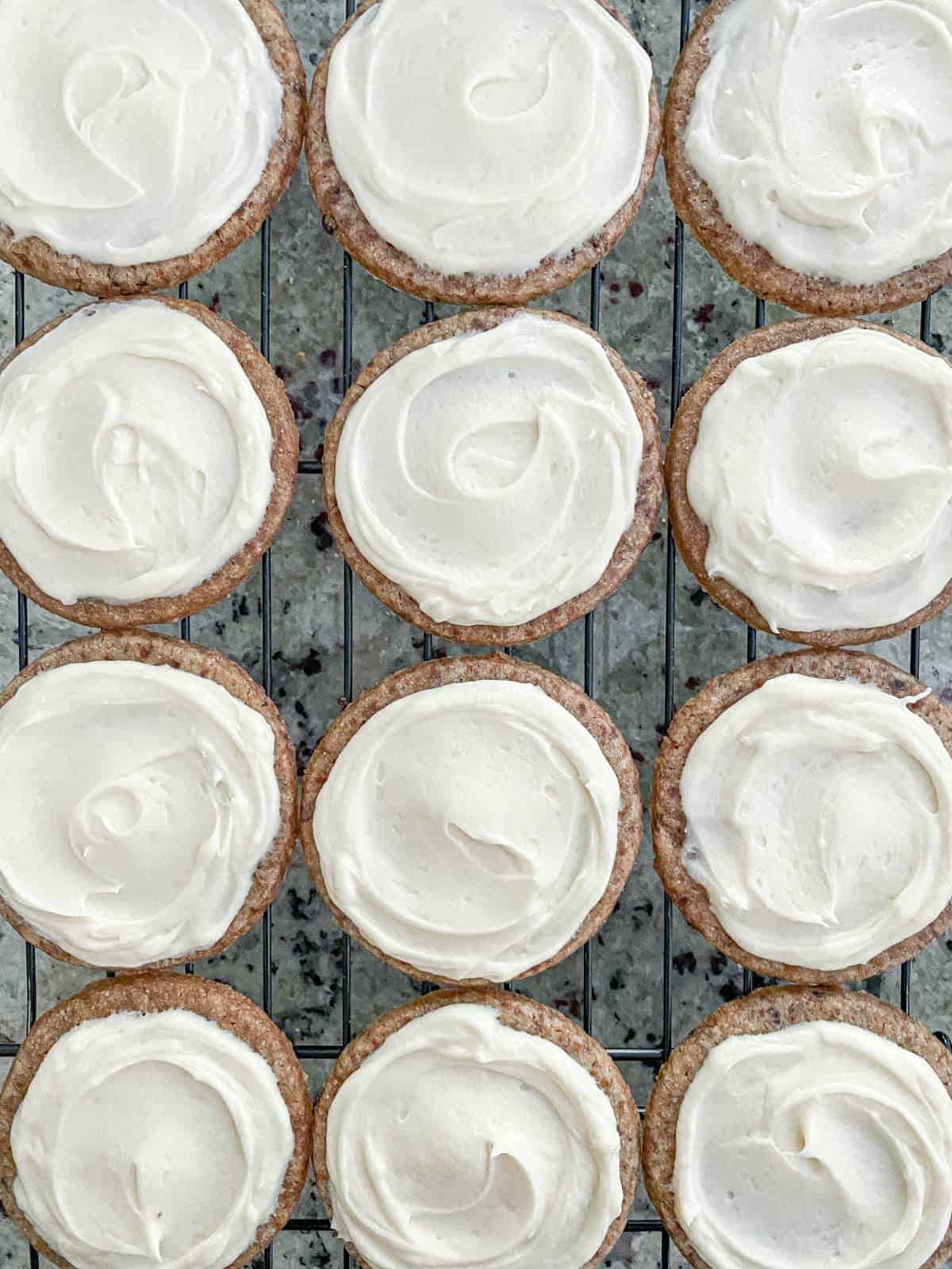 Frosted Honey Lavender Latte Cookies on a cooling rack.