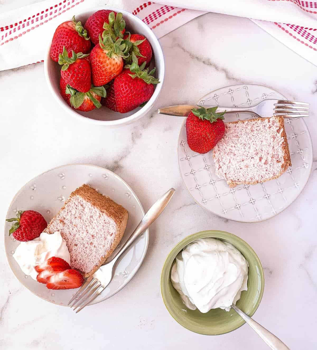 View of slices of Strawberry Angel Food Cake on plates from above.