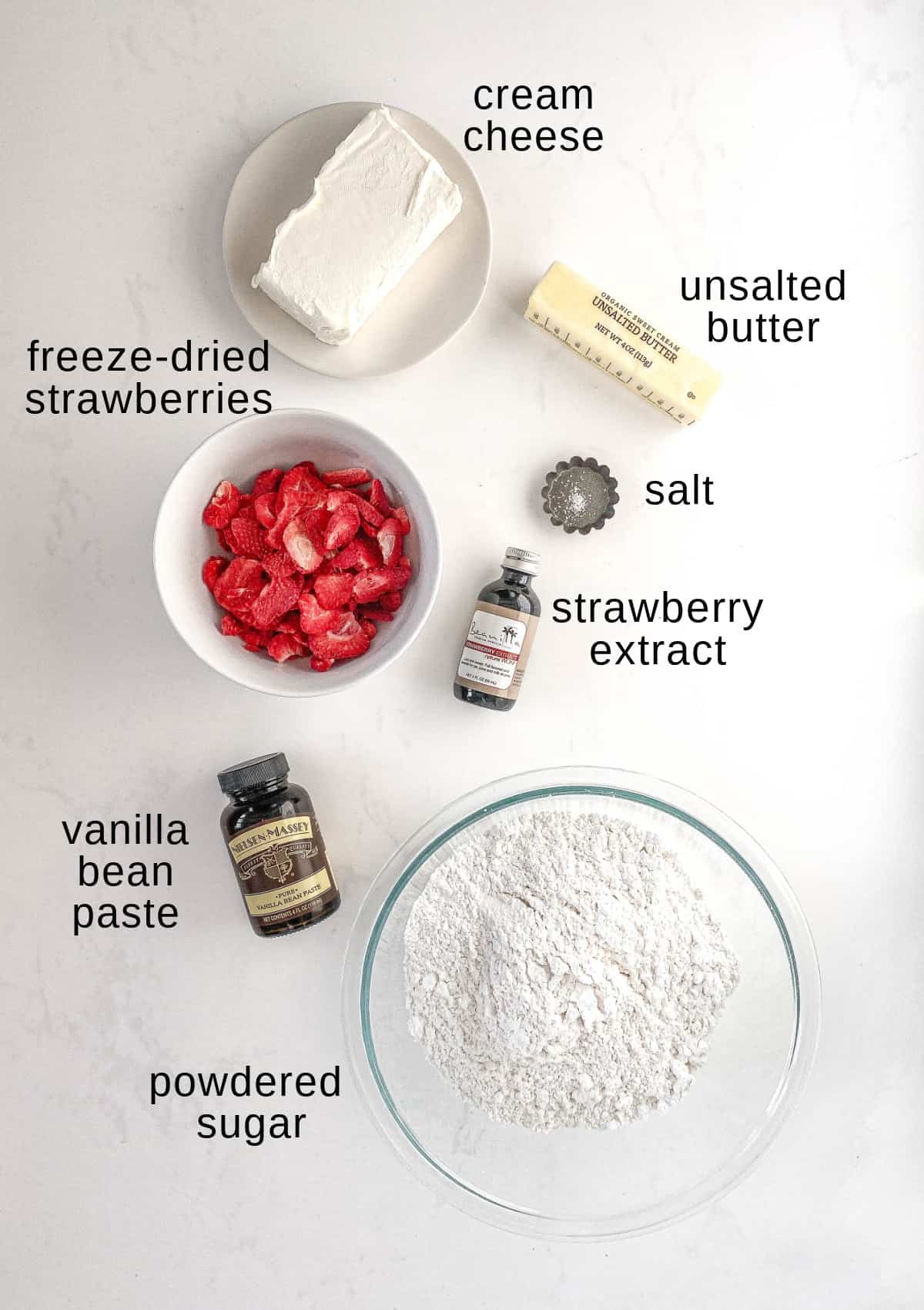 Strawberry cream cheese frosting ingredients on a white background.