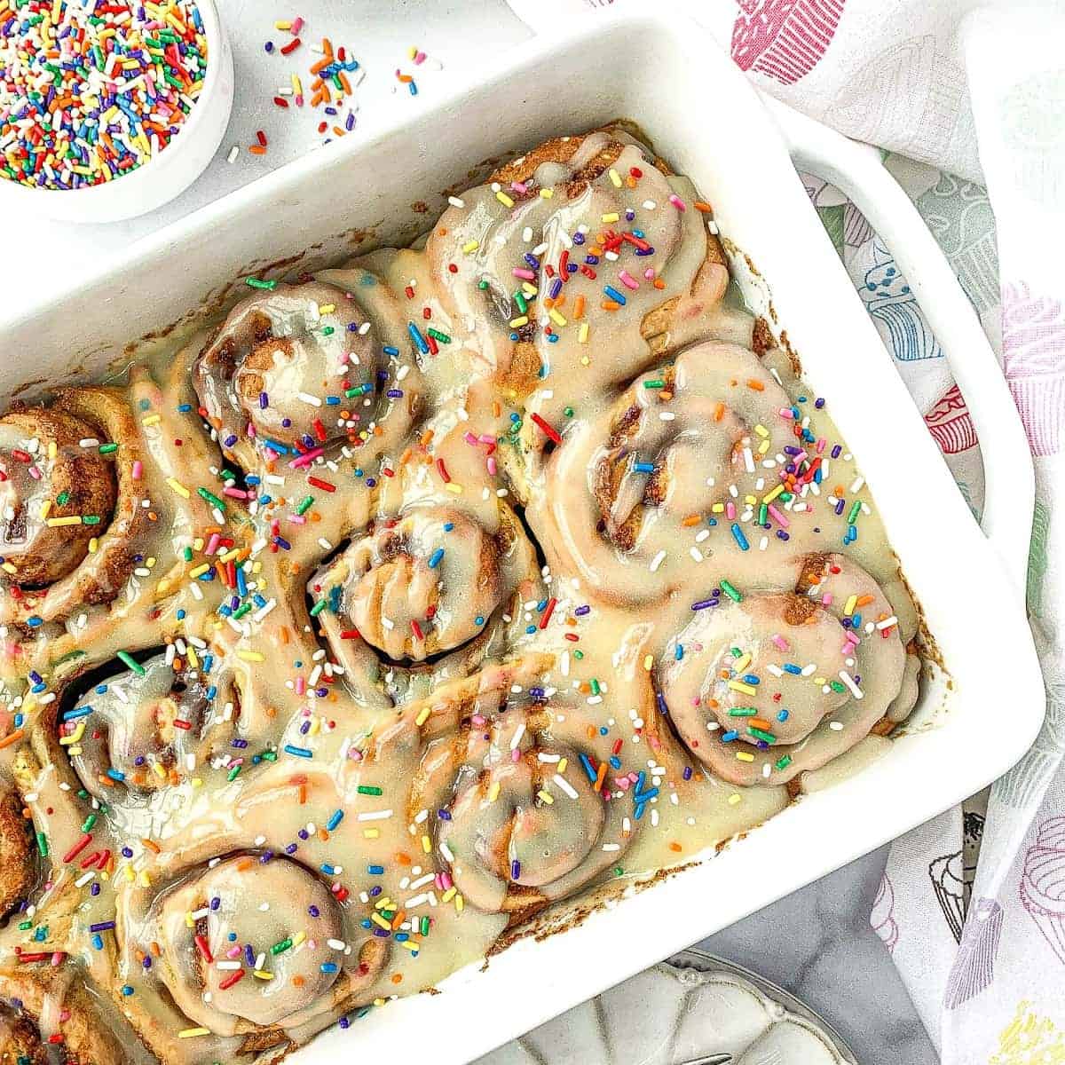 Funfetti Cinnamon Rolls with rainbow sprinkles on top.