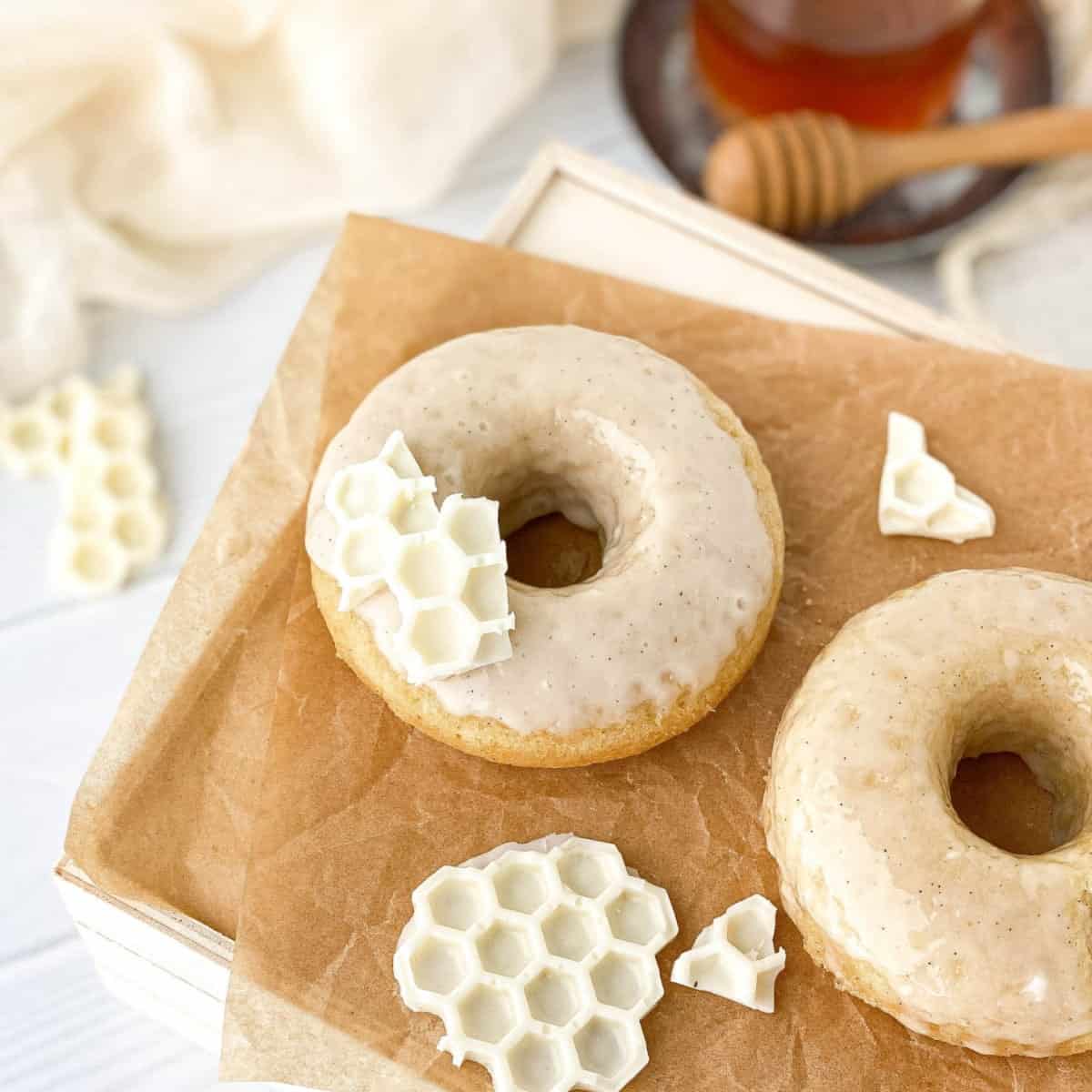 Honey Doughnuts with white chocolate "honeycomb" on parchment paper.