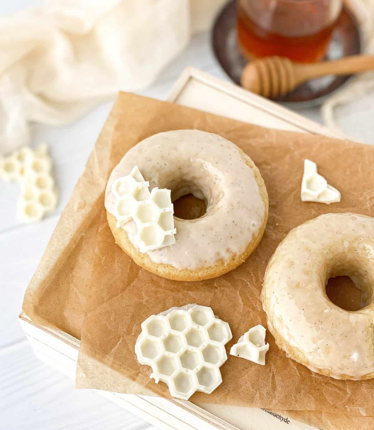Honey Doughnuts on parchment paper with white chocolate "honeycomb."
