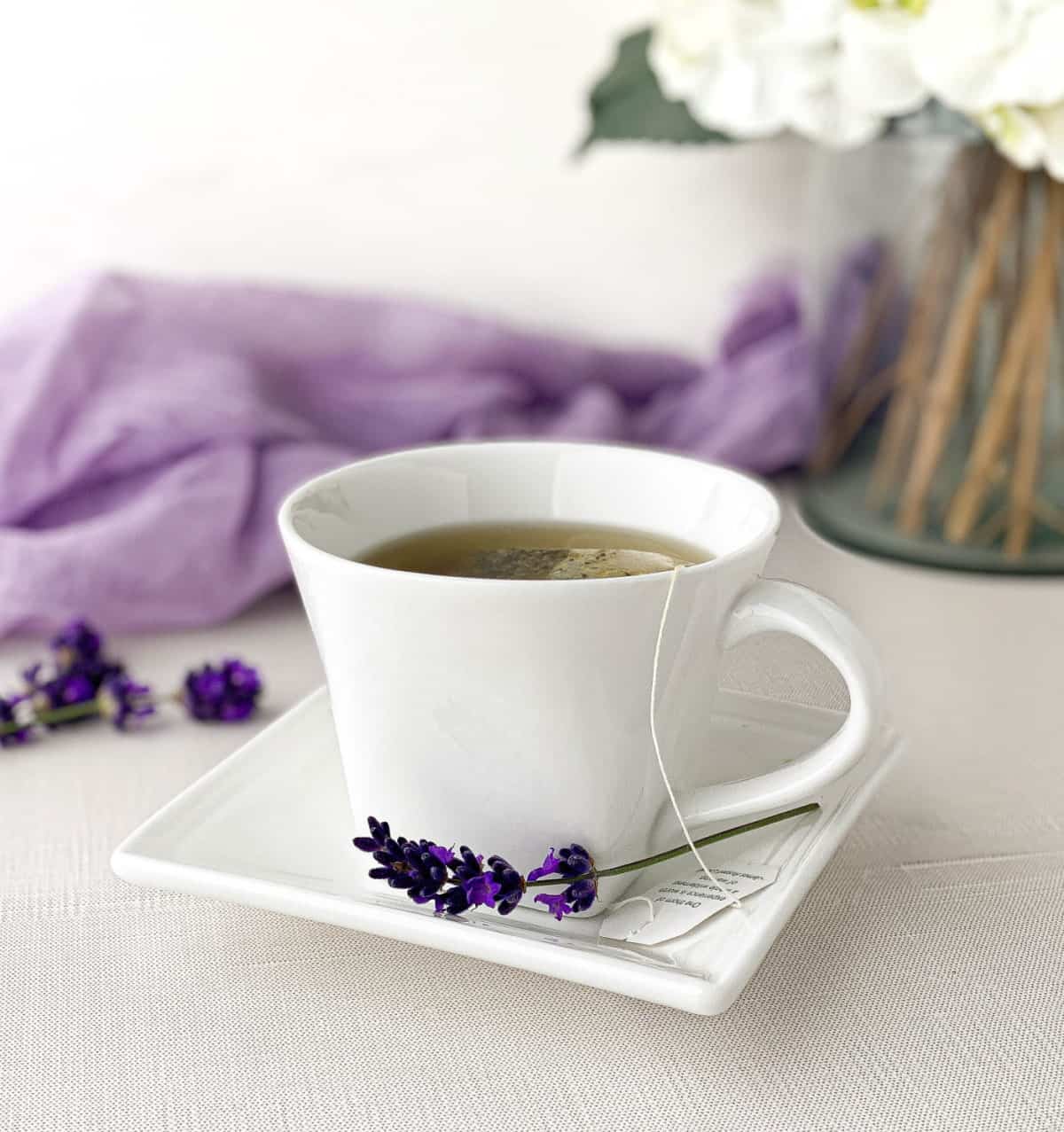 A cup of tea with Lavender Sugar in a white teacup.