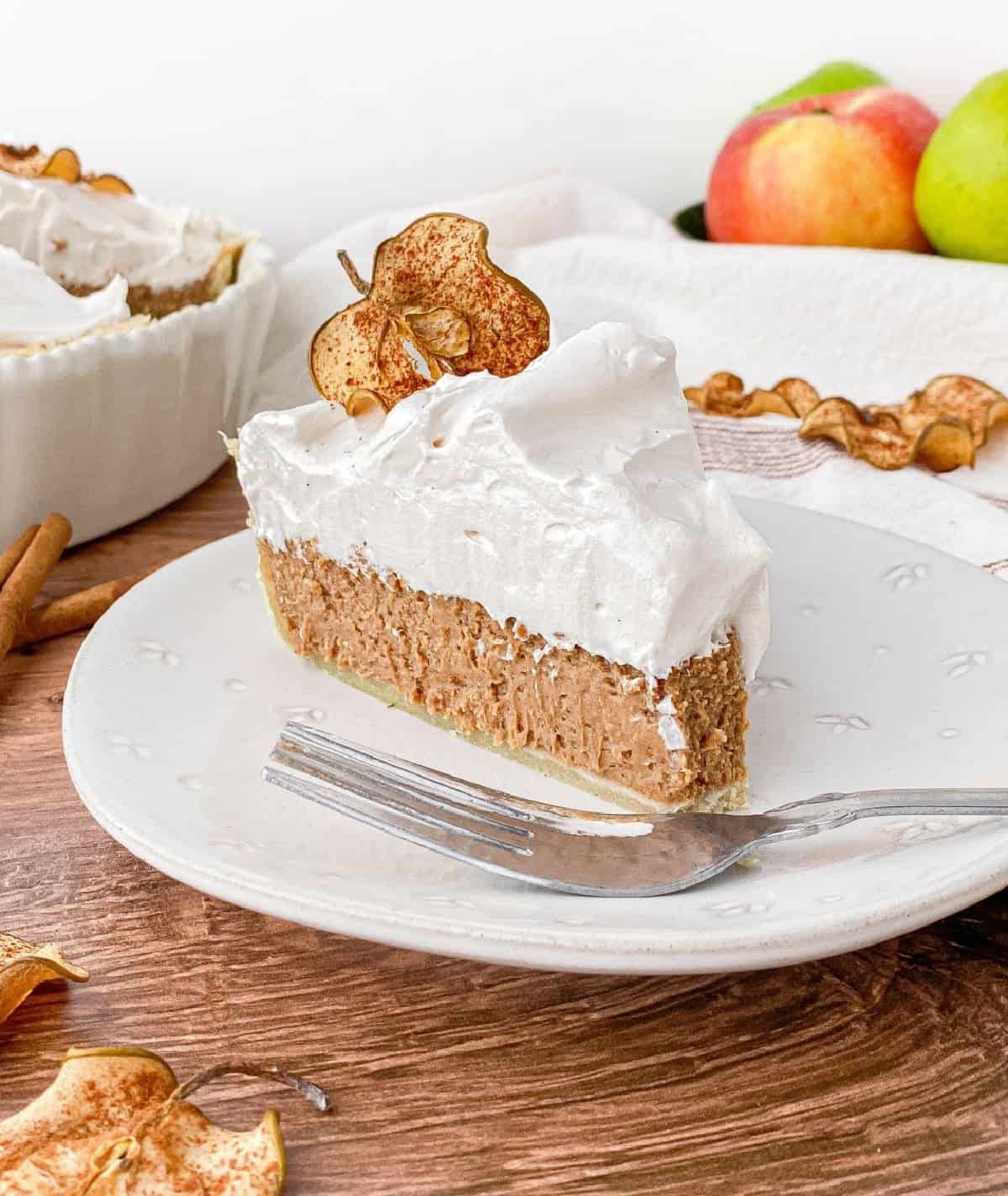 Slice of Cinnamon Pie with Apple Cider Meringue with a bite missing.