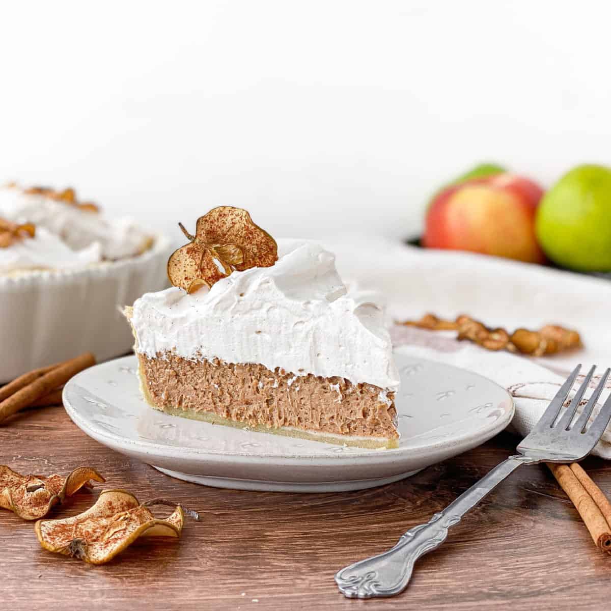 Slice of Cinnamon Pie with Apple Cider Meringue on a white plate.