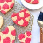 Honey Cookies with heart pattern on a gold cooling rack.