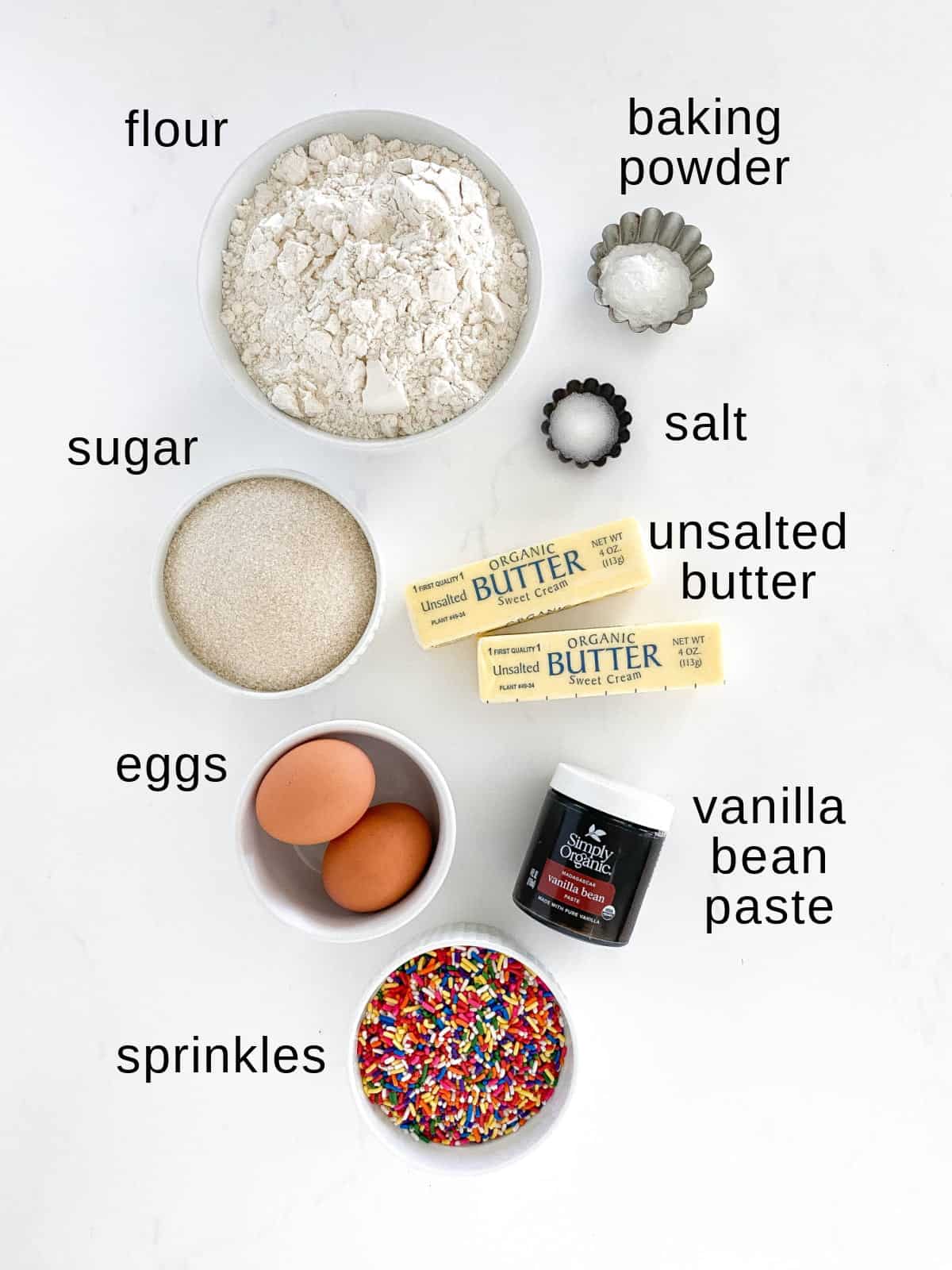 Sprinkle Cookies ingredients on a white background.