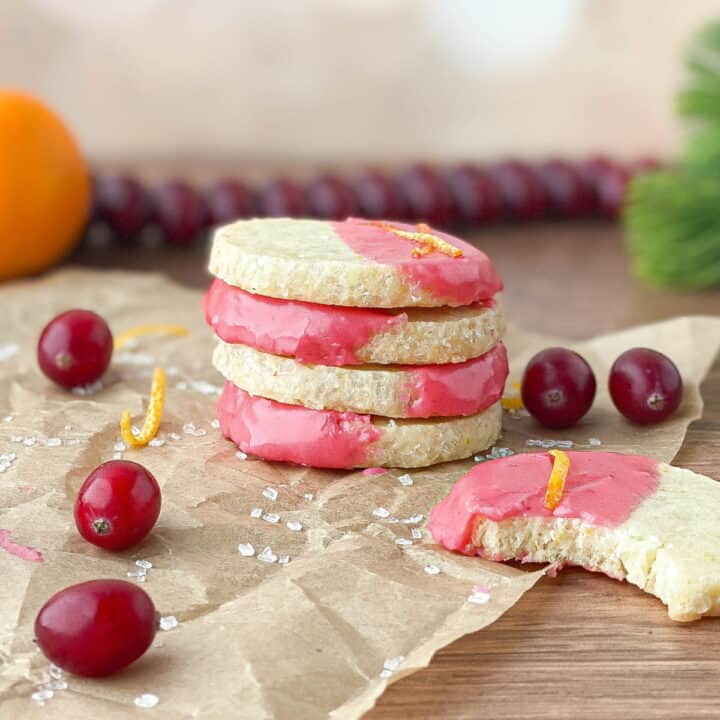 Stack of Orange Shortbread Cookies with Cranberry Glaze.