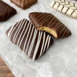 Closeup of Chocolate Covered Graham Crackers, one with a bite missing.