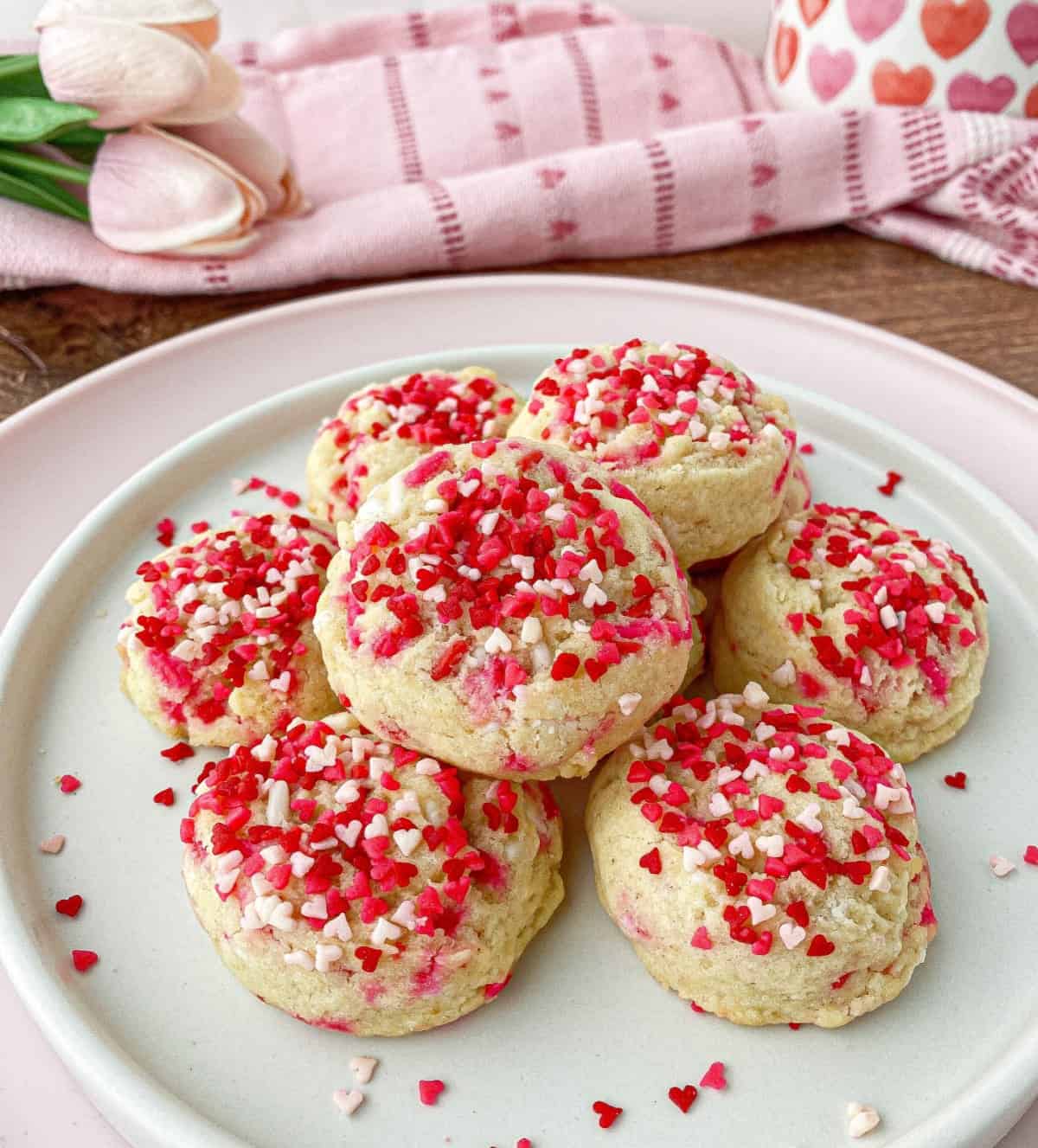 Valentine's Day Sprinkle Cookies stacked on a white plate.