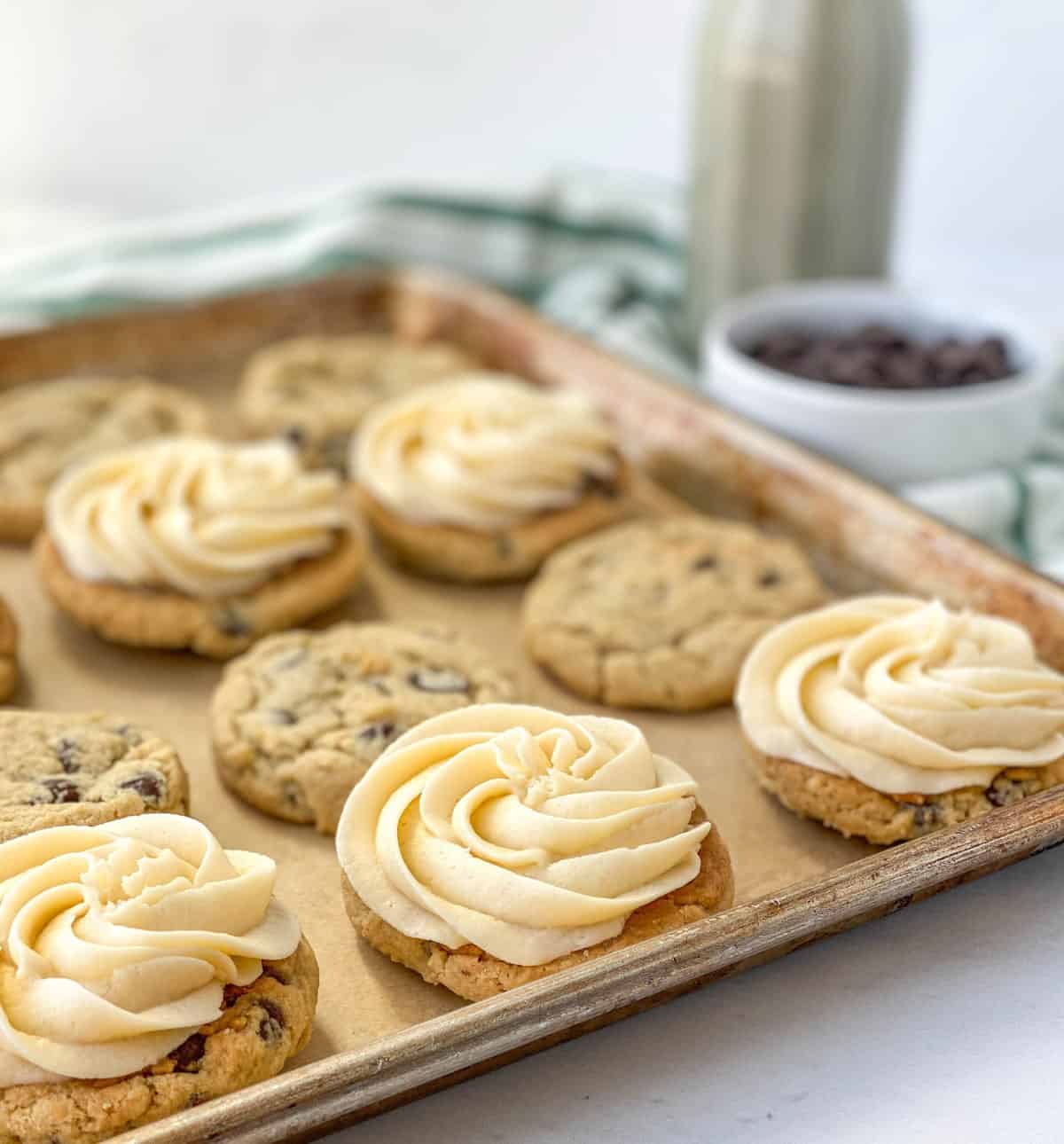 Bailey's Chocolate Chip Cookies topped with Bailey's buttercream on a baking sheet.
