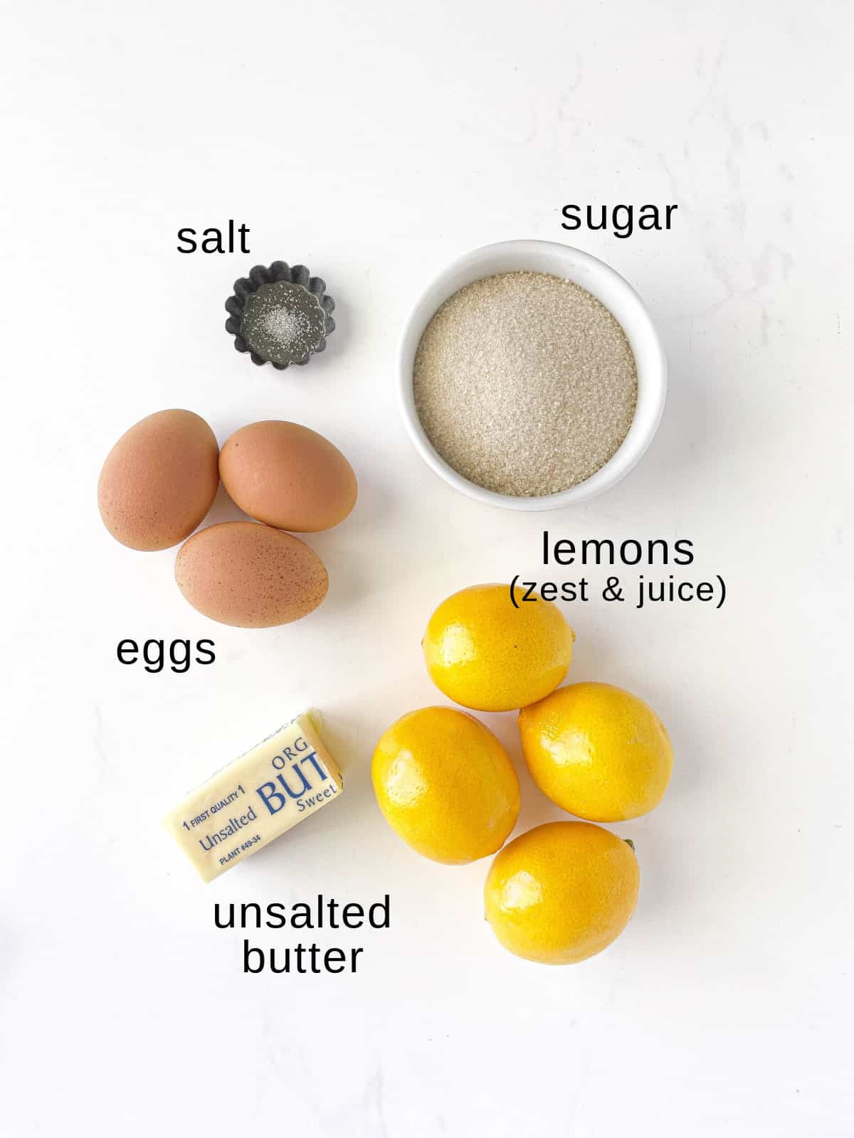 Lemon curd ingredients on a white background.