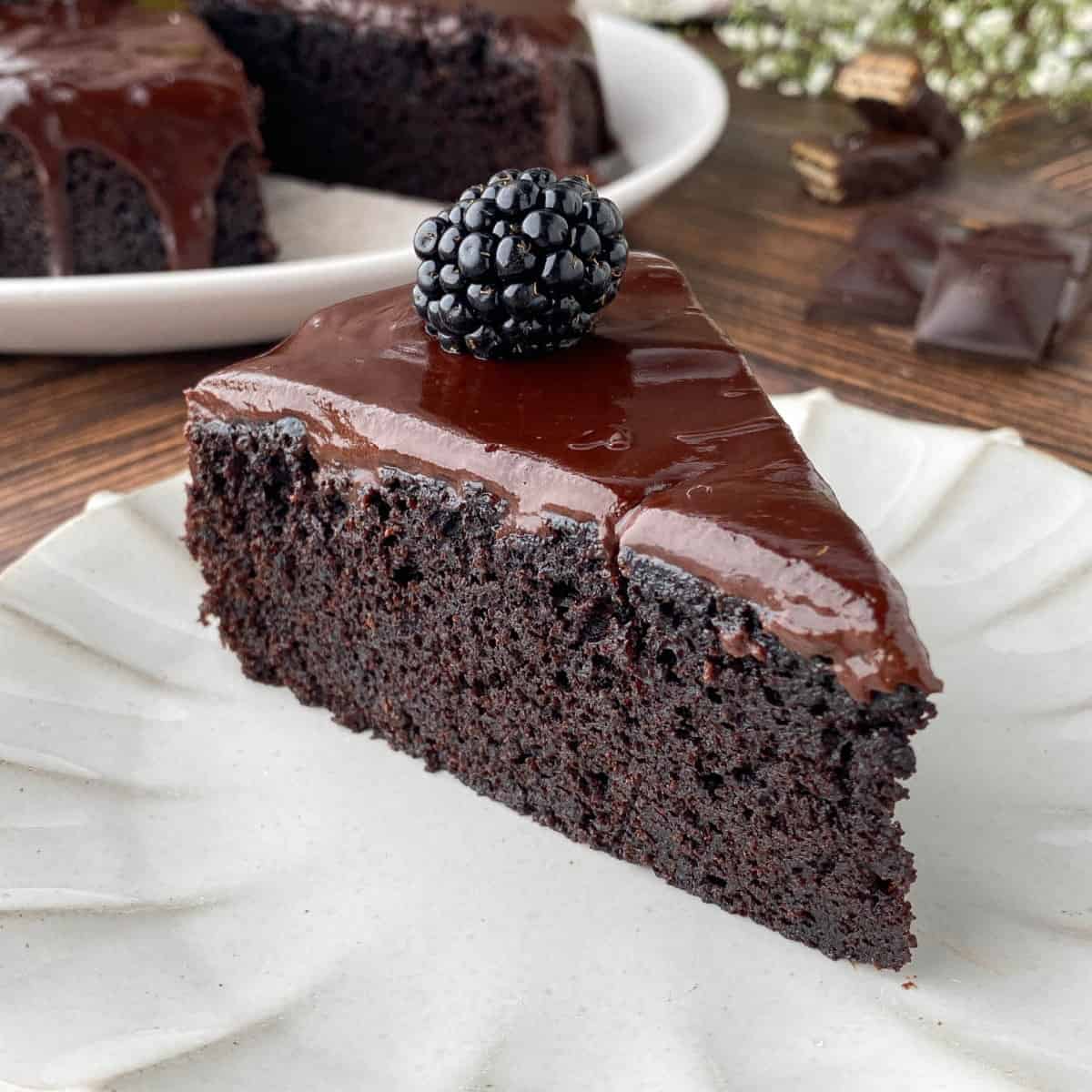 Slice of Chocolate Ganache Cake on a fluted plate.