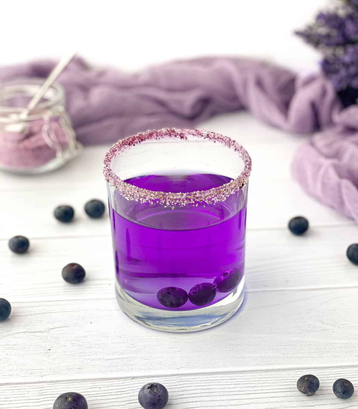 Purple cocktail with Blueberry Sugar on the rim of the glass.