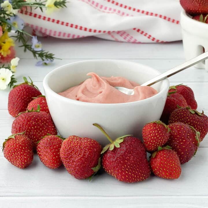 White Bowl of Strawberry Pastry Cream with fresh strawberries.
