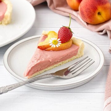Slice of Strawberry Peach Tart on a white plate.
