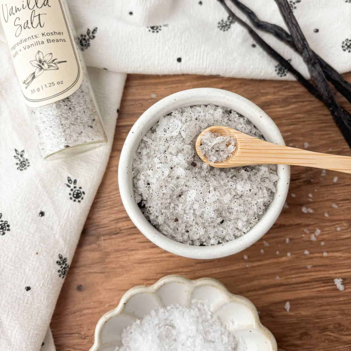 Top view of a small bowl filled with Vanilla Salt with a small wooden spoon.